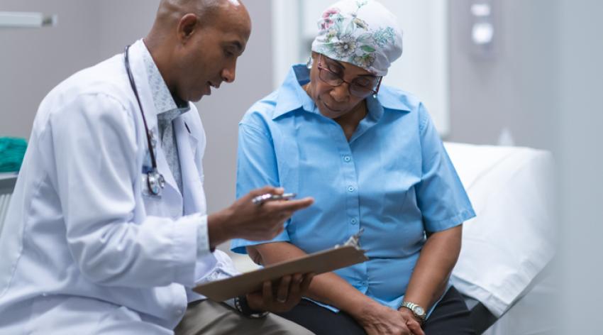 A doctor consults with a patient with cancer.